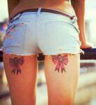 Bow tattoos on back of thighs.