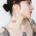 Tattoo of lips on neck.