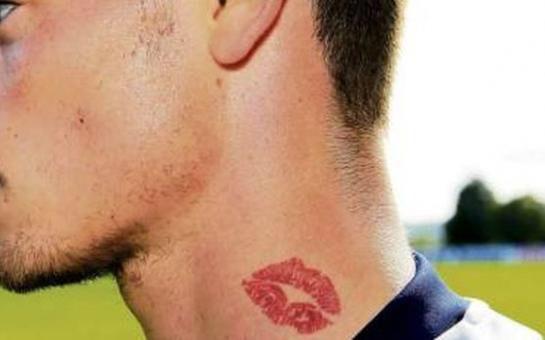 Tattoo of lips on neck.