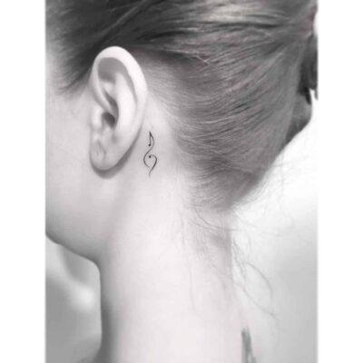 Music note tattoo behind ear